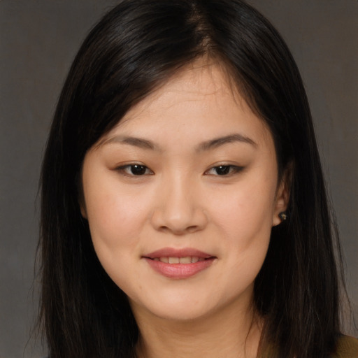 Joyful asian young-adult female with long  brown hair and brown eyes