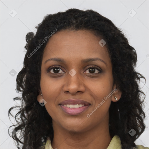 Joyful black young-adult female with long  brown hair and brown eyes