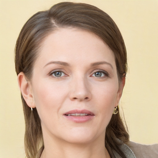 Joyful white young-adult female with long  brown hair and grey eyes