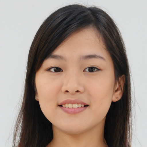 Joyful asian young-adult female with long  brown hair and brown eyes