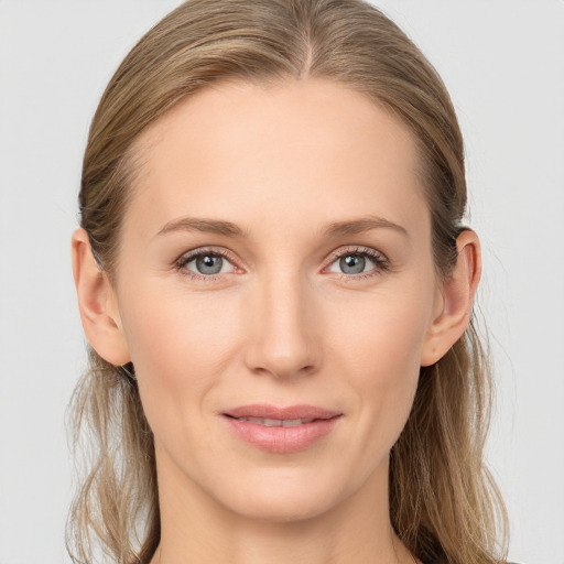 Joyful white young-adult female with medium  brown hair and blue eyes