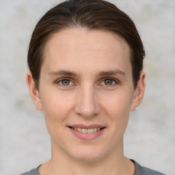 Joyful white young-adult female with short  brown hair and grey eyes