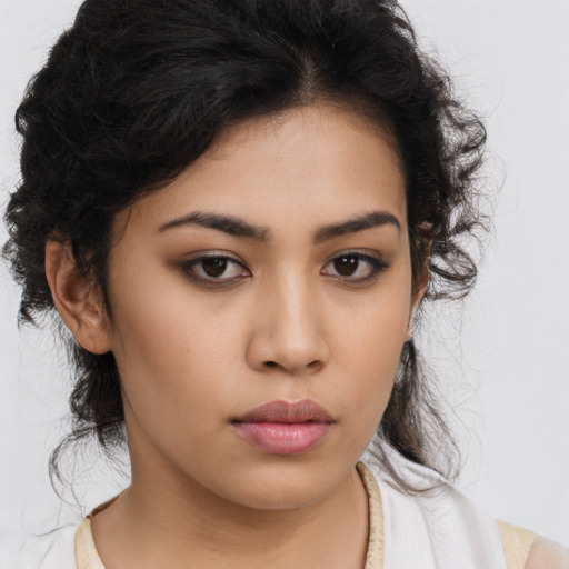 Neutral latino young-adult female with long  brown hair and brown eyes