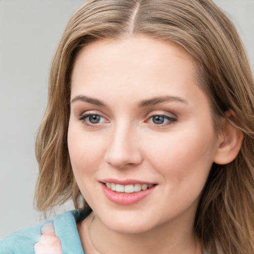 Joyful white young-adult female with long  brown hair and grey eyes