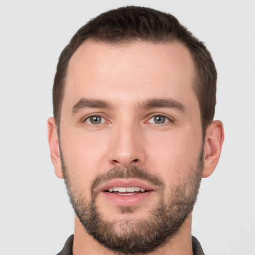 Joyful white young-adult male with short  brown hair and brown eyes