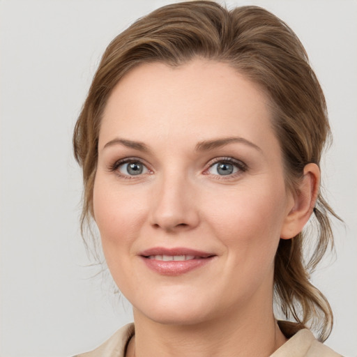 Joyful white young-adult female with medium  brown hair and blue eyes