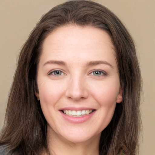 Joyful white young-adult female with long  brown hair and grey eyes