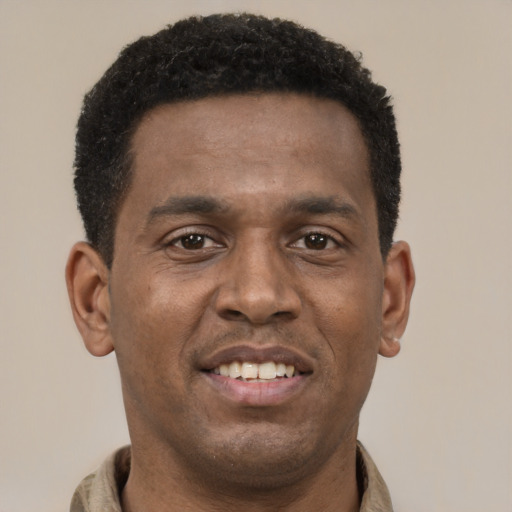 Joyful latino young-adult male with short  brown hair and brown eyes
