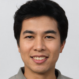 Joyful asian young-adult male with short  black hair and brown eyes