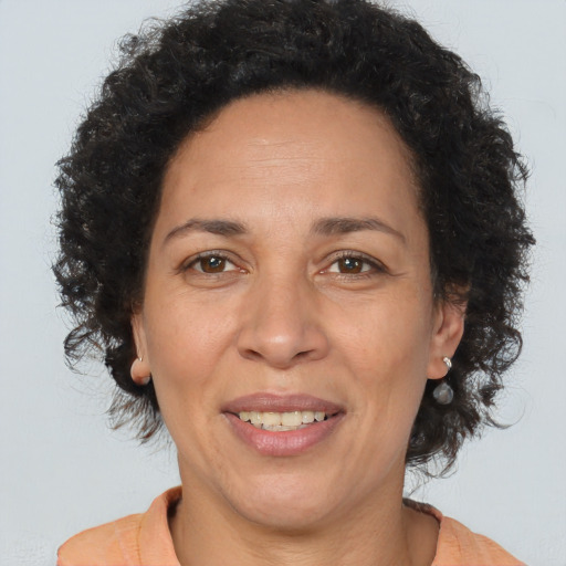 Joyful black adult female with short  brown hair and brown eyes
