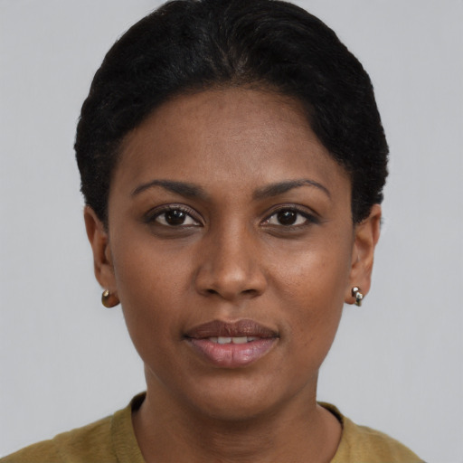 Joyful black young-adult female with short  brown hair and brown eyes