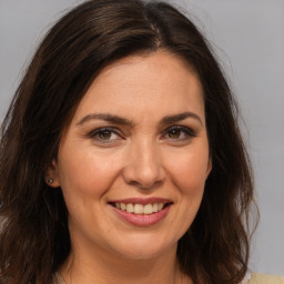 Joyful white adult female with medium  brown hair and brown eyes