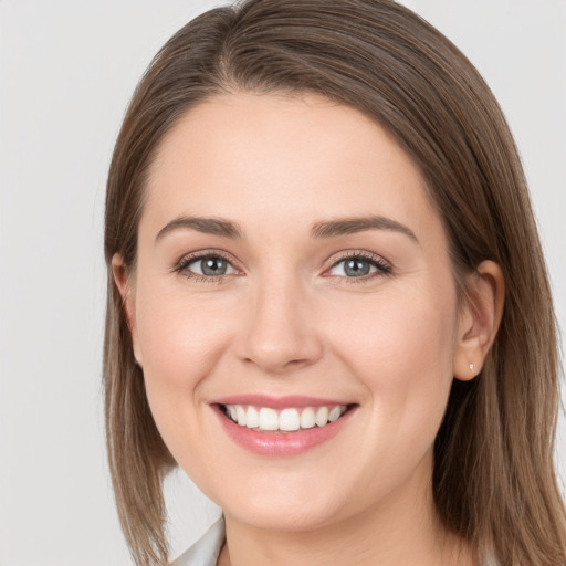 Joyful white young-adult female with long  brown hair and grey eyes