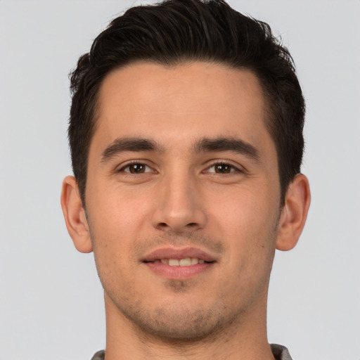 Joyful white young-adult male with short  brown hair and brown eyes