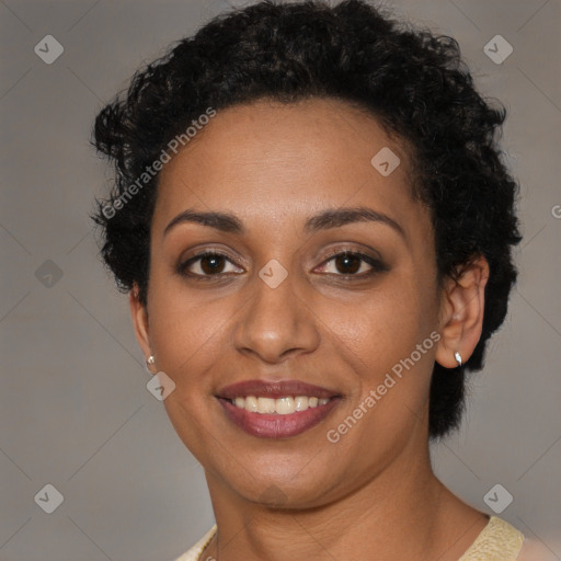 Joyful black young-adult female with short  brown hair and brown eyes