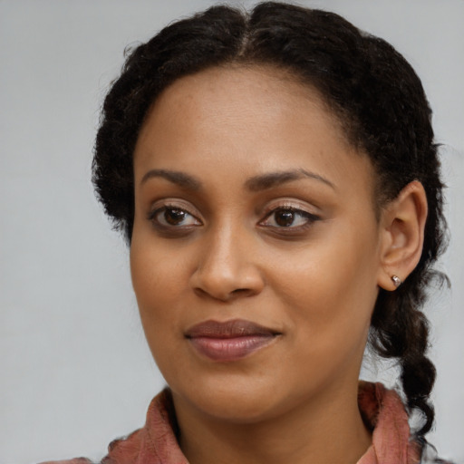 Joyful black young-adult female with medium  brown hair and brown eyes