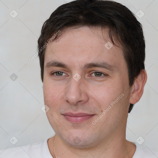 Joyful white adult male with short  brown hair and brown eyes