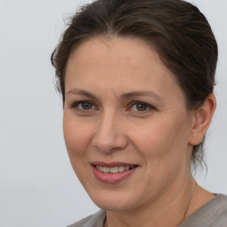 Joyful white adult female with medium  brown hair and brown eyes