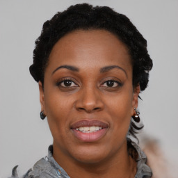 Joyful black young-adult female with short  black hair and brown eyes