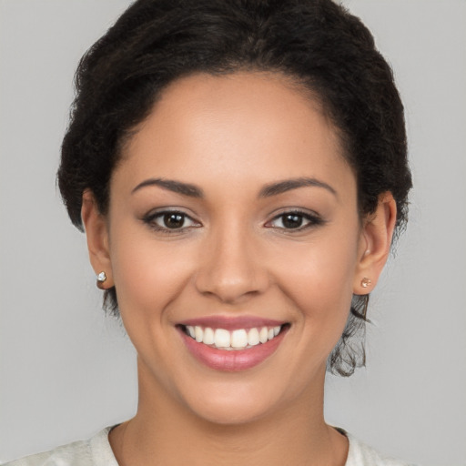 Joyful latino young-adult female with short  brown hair and brown eyes