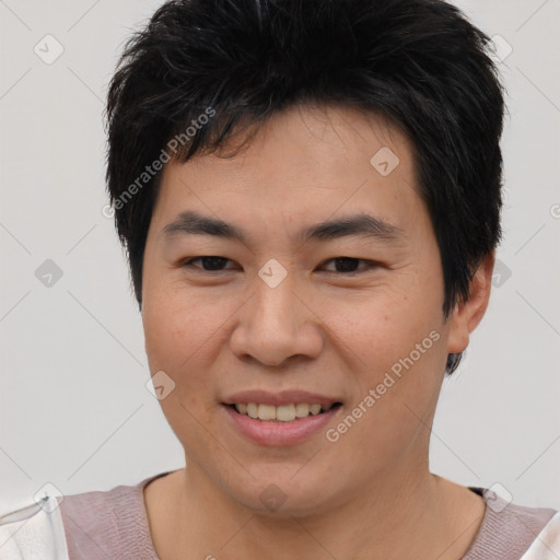 Joyful asian young-adult male with short  brown hair and brown eyes