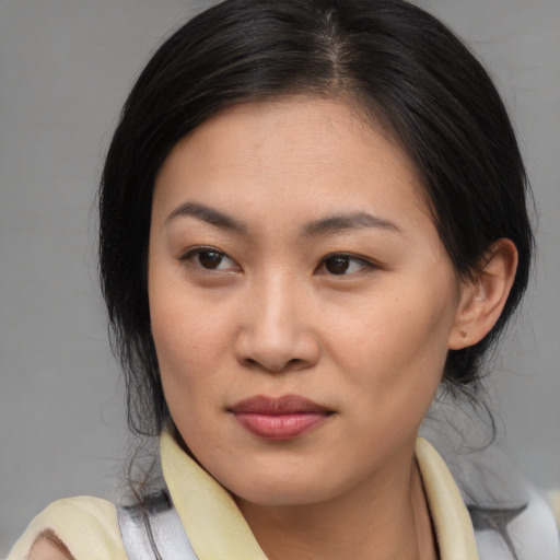 Joyful asian young-adult female with medium  brown hair and brown eyes