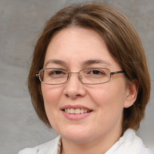 Joyful white adult female with medium  brown hair and blue eyes