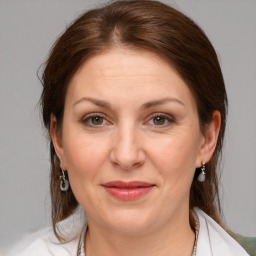 Joyful white adult female with medium  brown hair and brown eyes