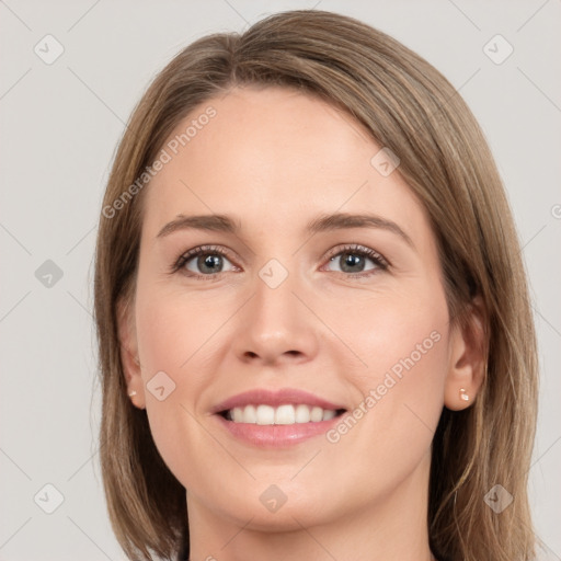 Joyful white young-adult female with medium  brown hair and grey eyes