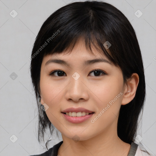 Joyful asian young-adult female with medium  black hair and brown eyes