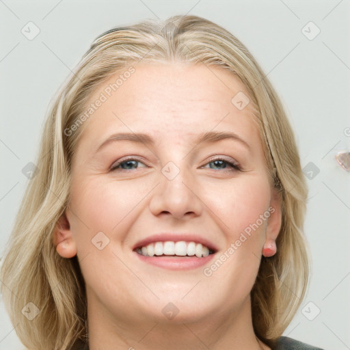 Joyful white young-adult female with long  brown hair and blue eyes