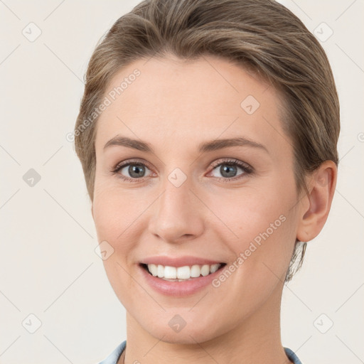 Joyful white young-adult female with short  brown hair and grey eyes