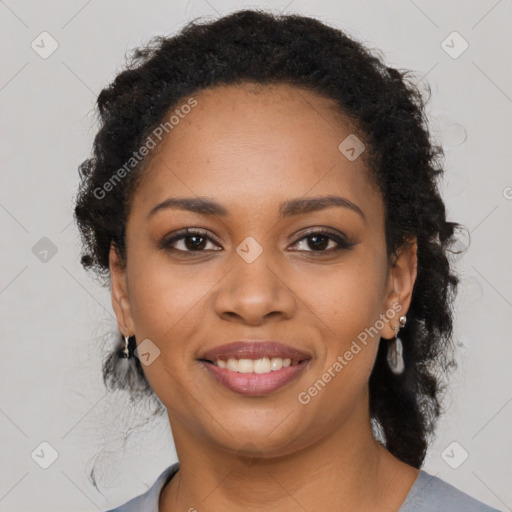 Joyful black young-adult female with long  brown hair and brown eyes