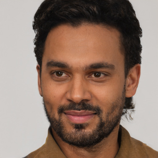 Joyful black young-adult male with short  black hair and brown eyes