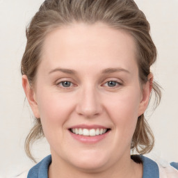 Joyful white young-adult female with medium  brown hair and blue eyes