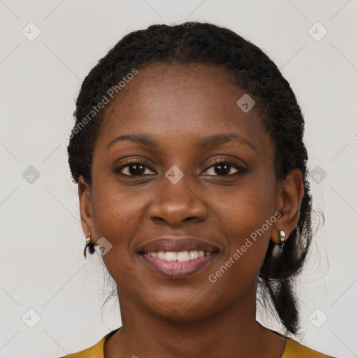 Joyful black young-adult female with long  black hair and brown eyes