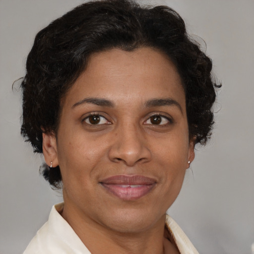 Joyful latino adult female with short  brown hair and brown eyes