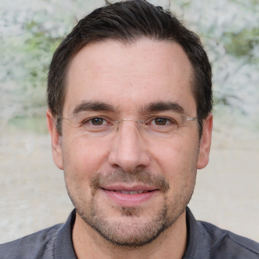 Joyful white adult male with short  brown hair and brown eyes