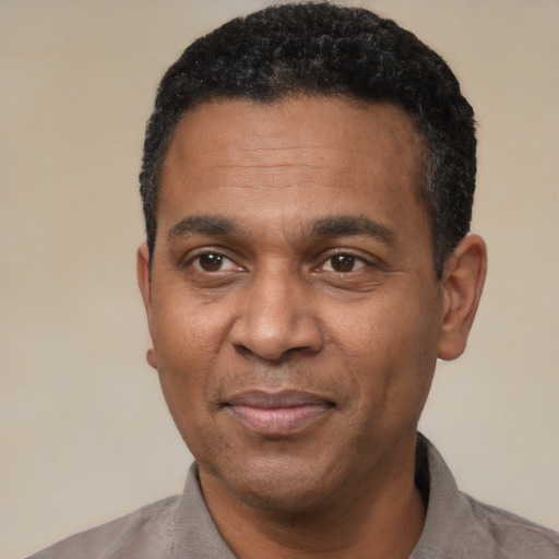Joyful latino adult male with short  black hair and brown eyes