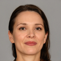 Joyful white adult female with medium  brown hair and brown eyes