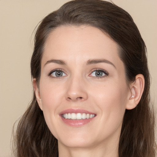 Joyful white young-adult female with long  brown hair and brown eyes