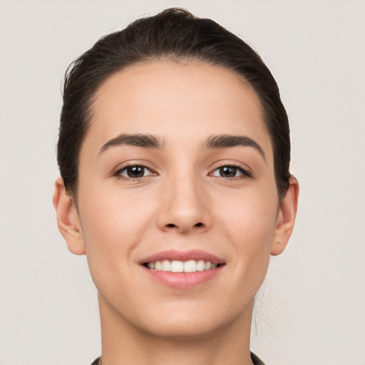 Joyful white young-adult female with short  brown hair and brown eyes