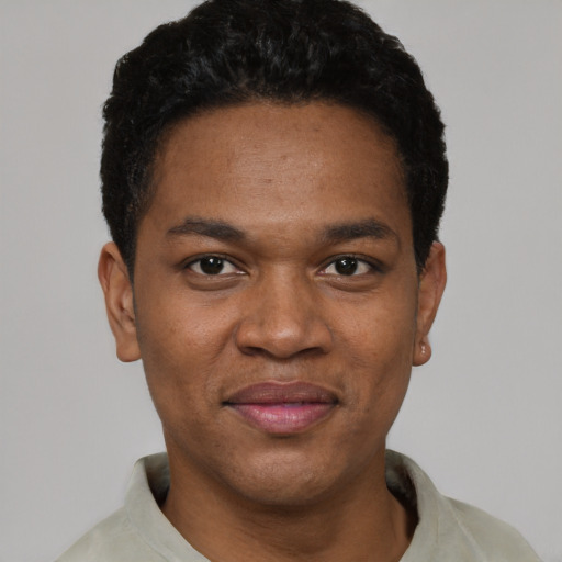 Joyful black young-adult male with short  black hair and brown eyes