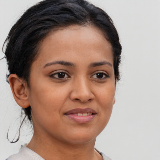 Joyful latino young-adult female with short  brown hair and brown eyes