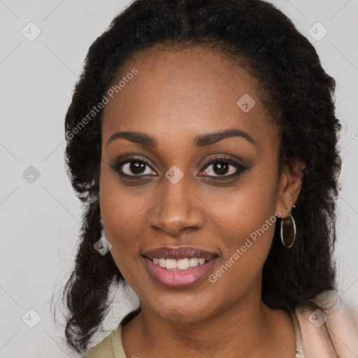 Joyful black young-adult female with long  brown hair and brown eyes