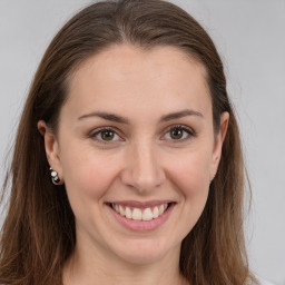 Joyful white young-adult female with long  brown hair and brown eyes