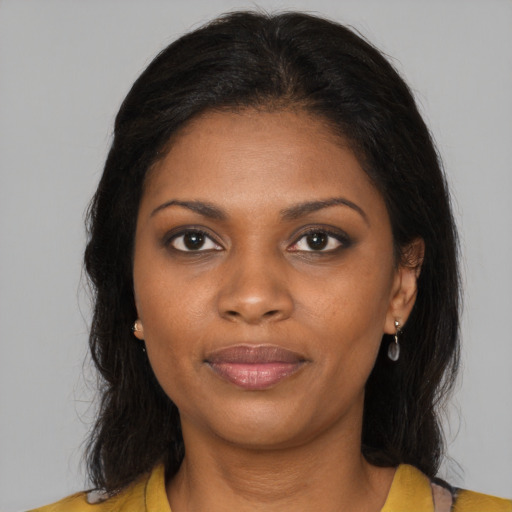 Joyful black young-adult female with medium  brown hair and brown eyes