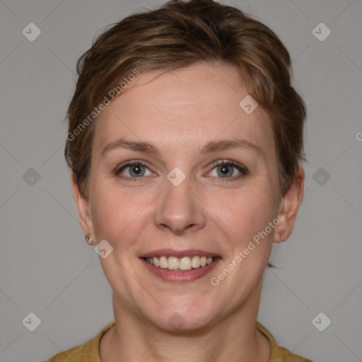 Joyful white adult female with medium  brown hair and blue eyes