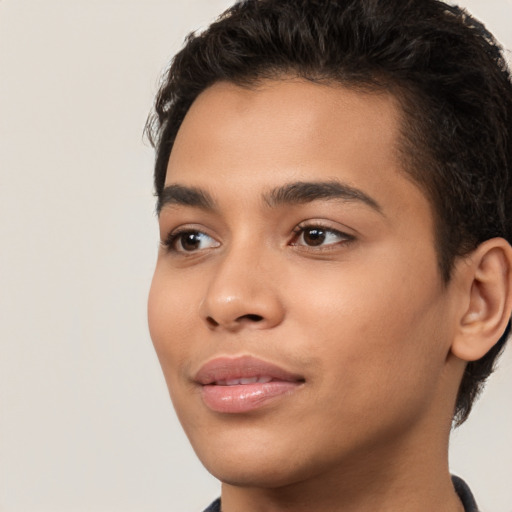 Joyful latino young-adult male with short  brown hair and brown eyes