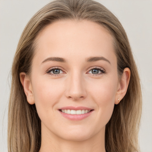 Joyful white young-adult female with long  brown hair and grey eyes